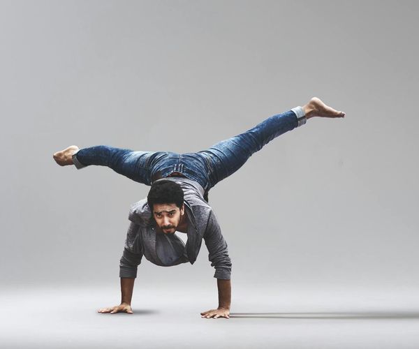 Man performing a challenging balance yoga pose.